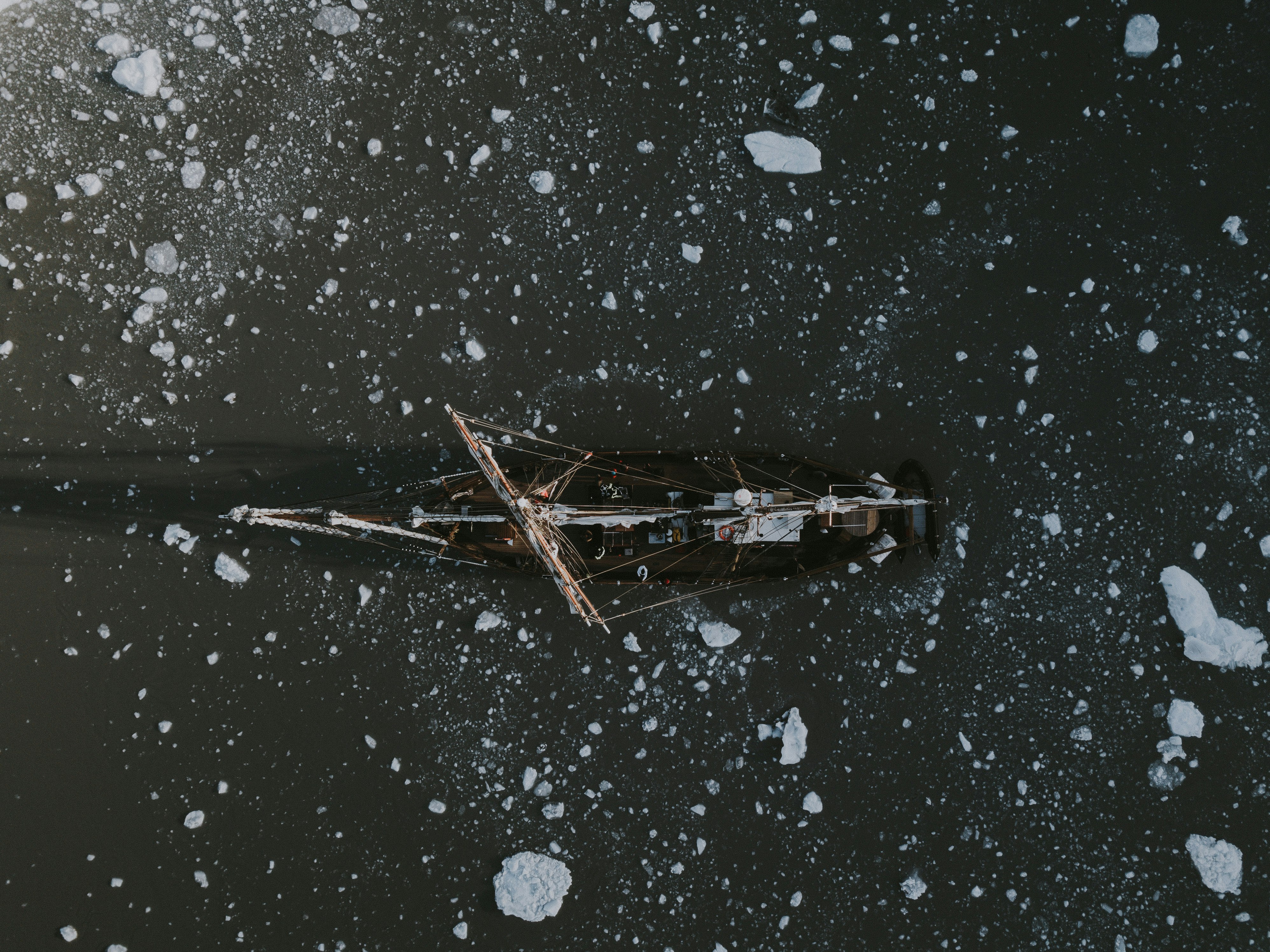 boat on body of water with icebergs